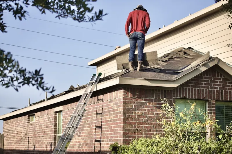 Professional roofer working on a residential roof in Kemblesville